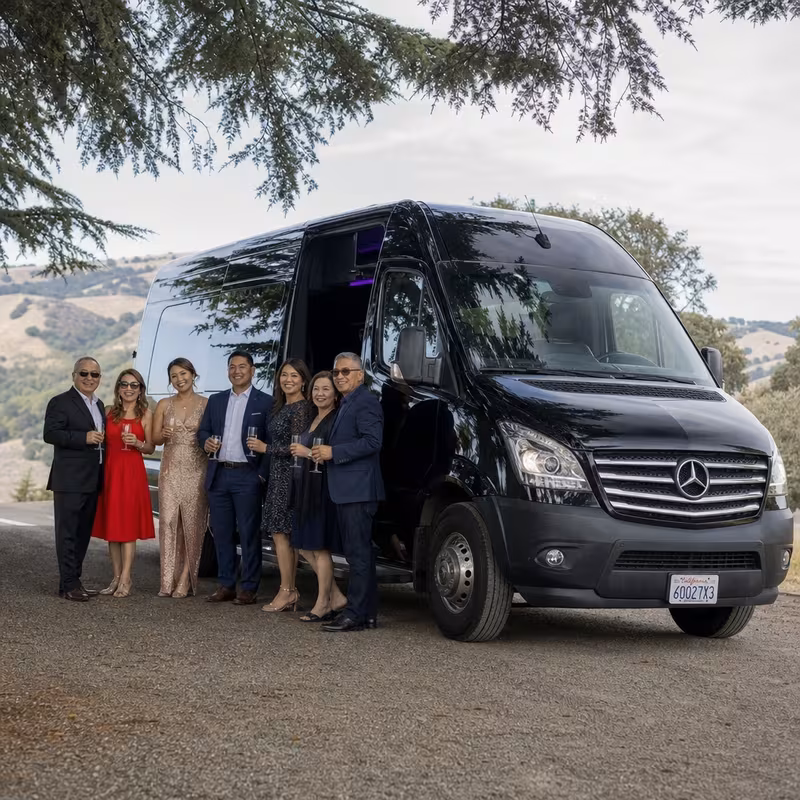 Group beside a Mercedes Sprinter limo from the Oakland fleet