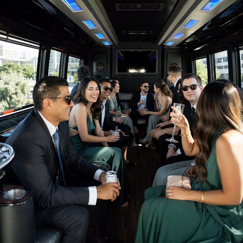 Wedding guests seated inside a Oakland party bus