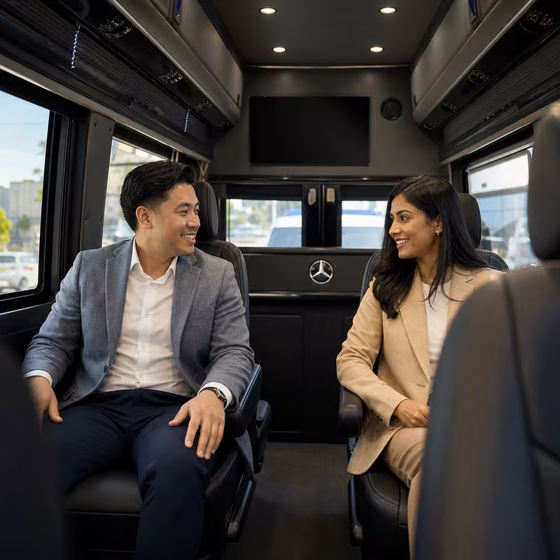 Group boarding a white charter bus for Corporate Transportation transportation in Oakland