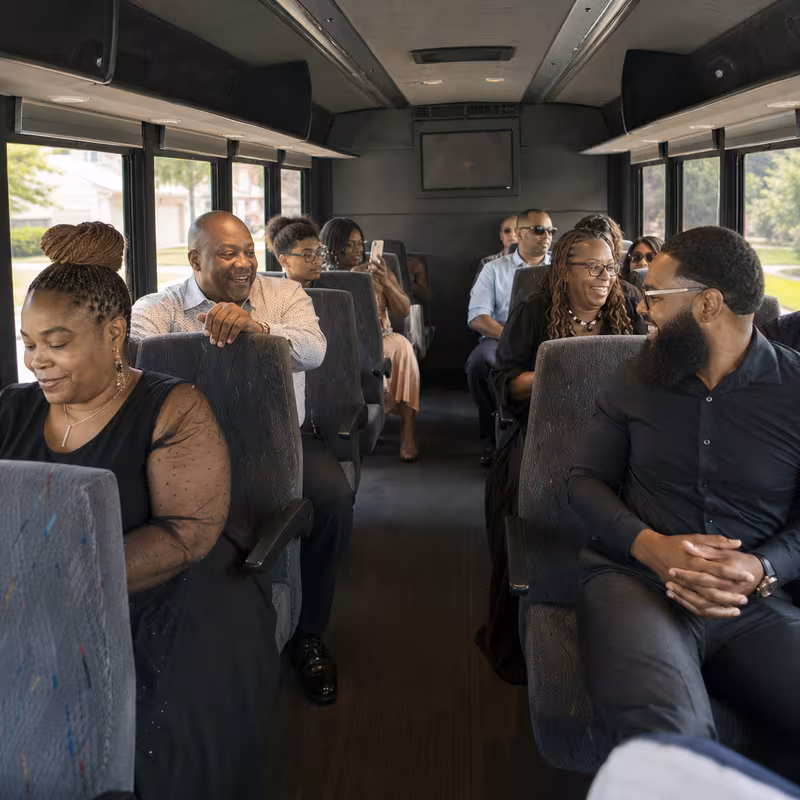 Group boarding a white charter bus for Private Event Transportation transportation in Oakland