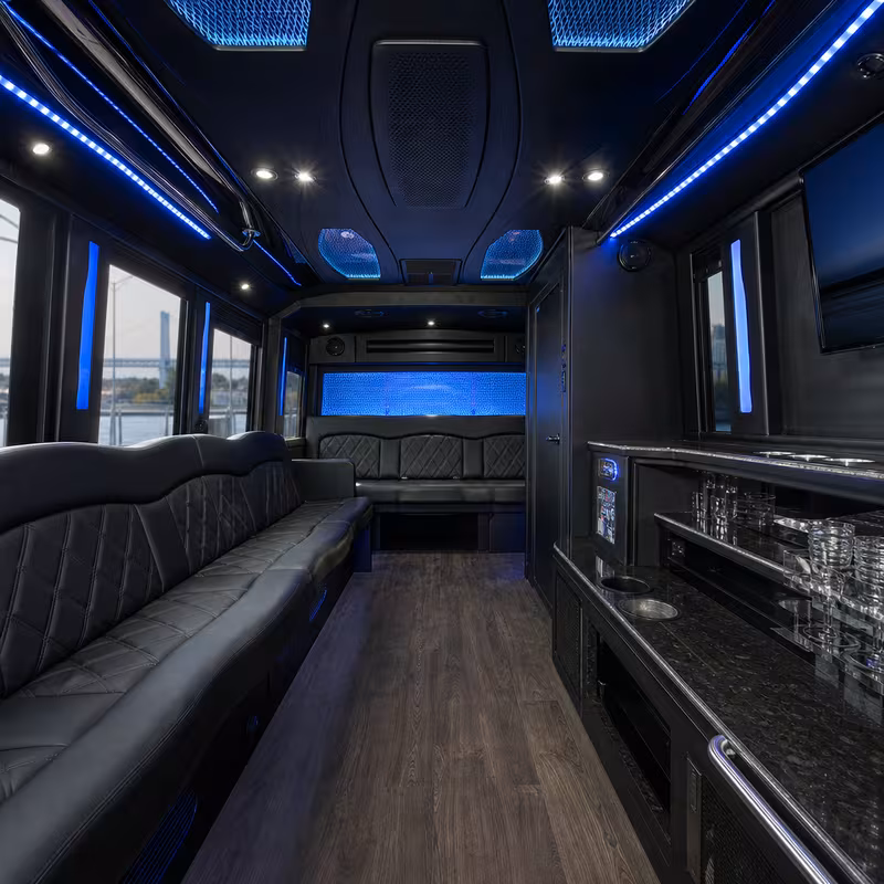 Party bus interior with wraparound leather seating and LED lighting in Oakland