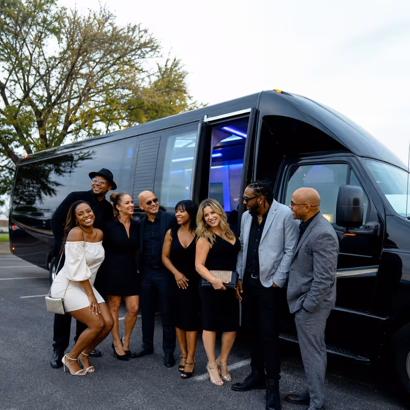 Passengers loading luggage while boarding an Oakland group shuttle