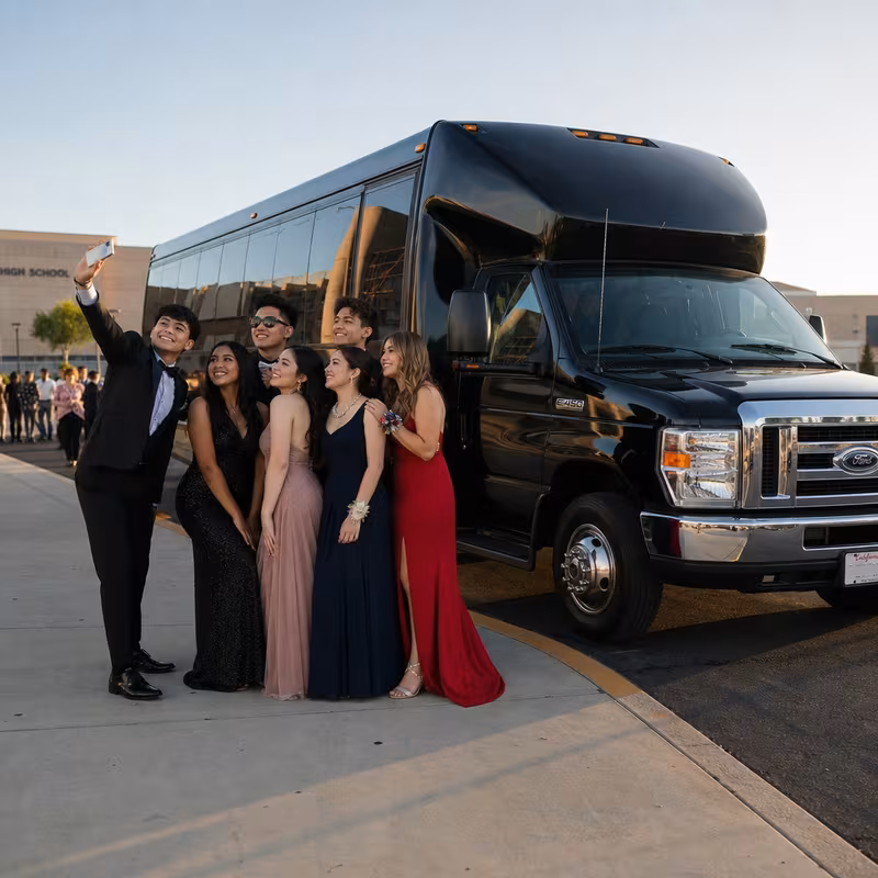 Group boarding a white charter bus for Prom & Homecoming Transportation transportation in Oakland