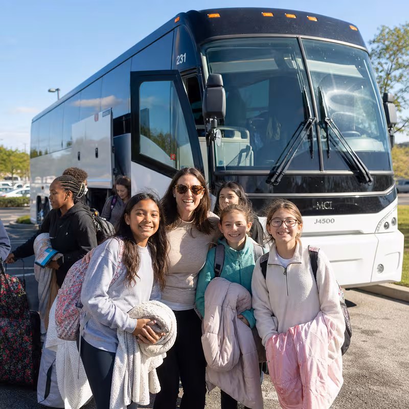 Passengers loading luggage while boarding an Oakland group shuttle