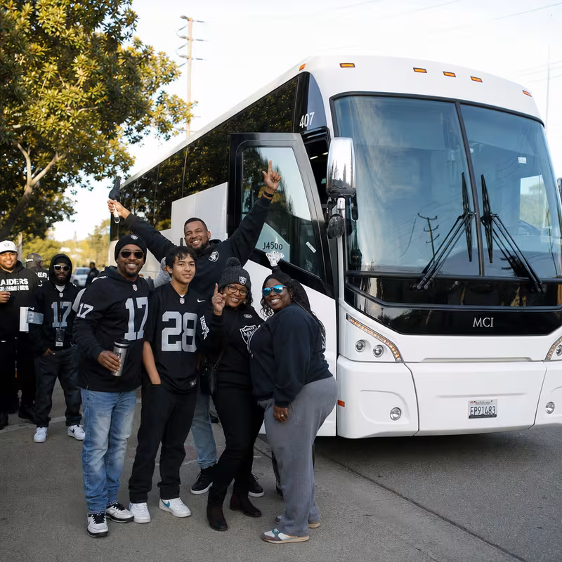 Passengers loading luggage while boarding an Oakland group shuttle