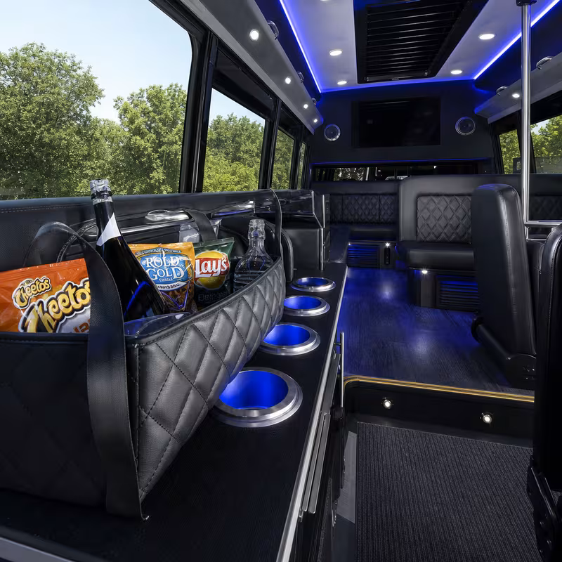 Party bus interior with wraparound leather seating and LED lighting in Oakland