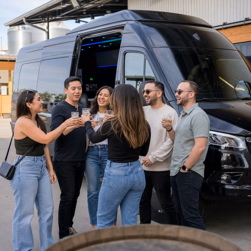 Passengers loading luggage while boarding an Oakland group shuttle
